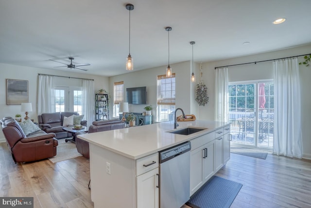 kitchen with white cabinets, stainless steel dishwasher, and a healthy amount of sunlight