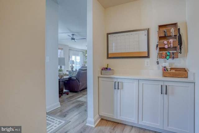 hallway with light hardwood / wood-style floors