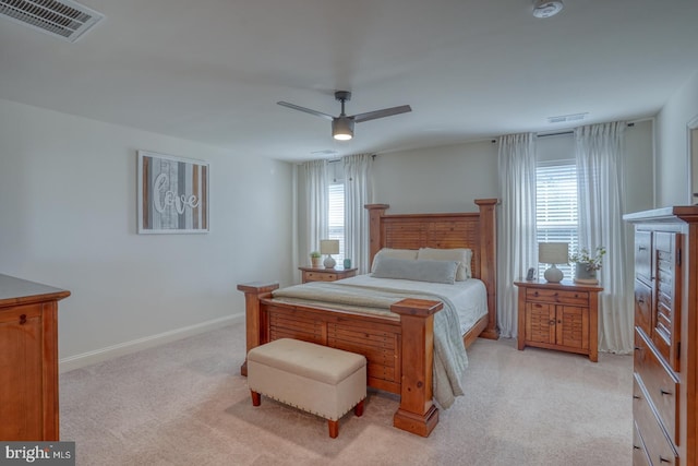 carpeted bedroom featuring ceiling fan and multiple windows