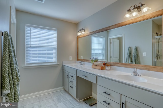 bathroom with tile patterned floors, vanity, and walk in shower