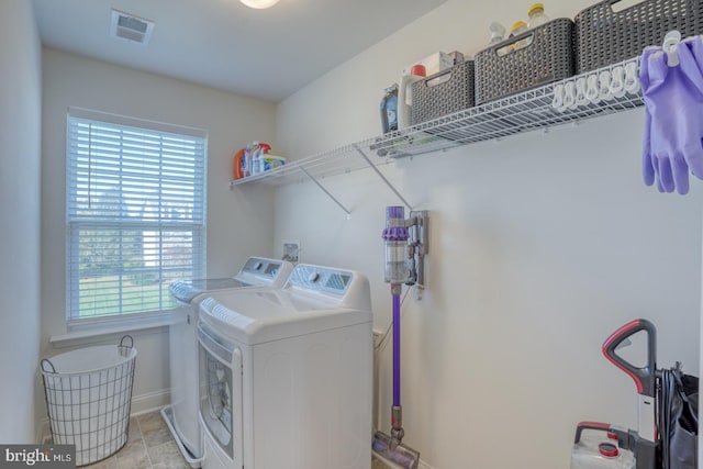 washroom with a wealth of natural light and washing machine and clothes dryer