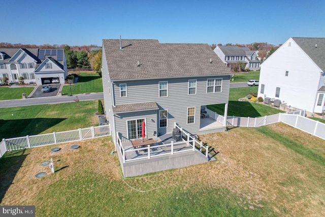 rear view of house featuring a yard