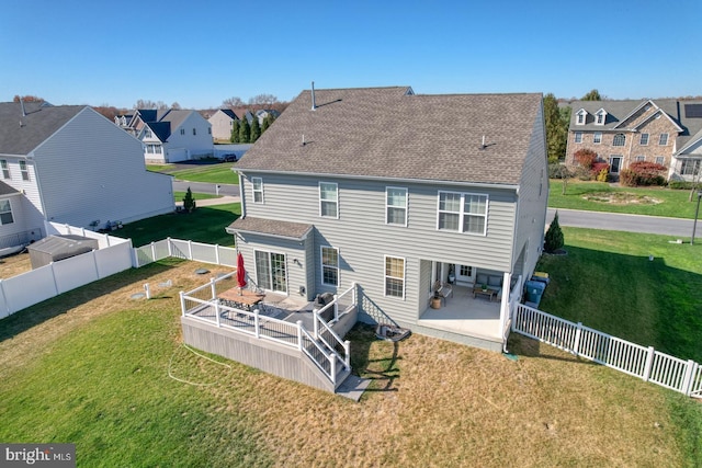 rear view of house with a yard and a patio