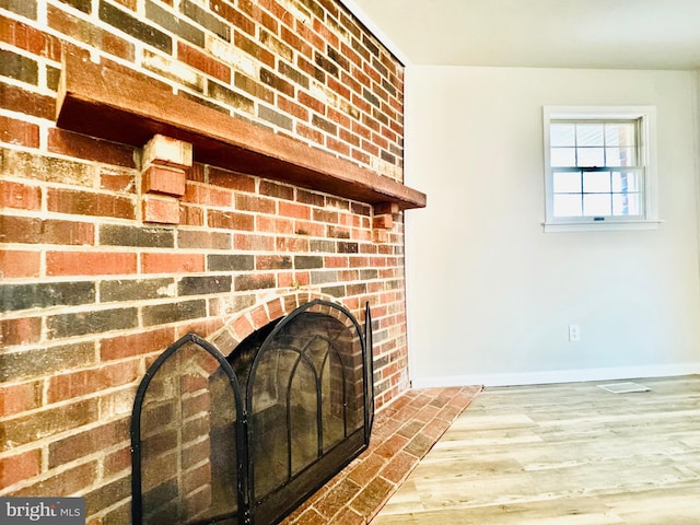 details featuring a fireplace and hardwood / wood-style floors