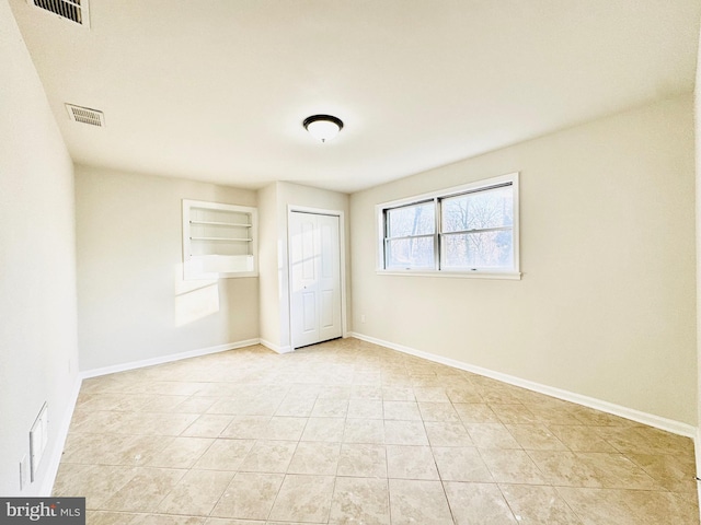 unfurnished bedroom featuring a closet and light tile patterned floors