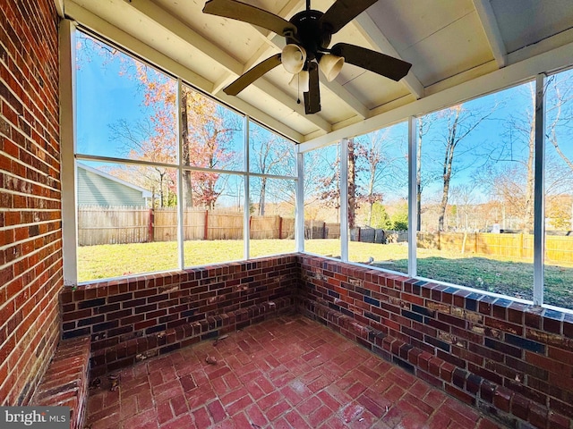 unfurnished sunroom featuring vaulted ceiling and ceiling fan