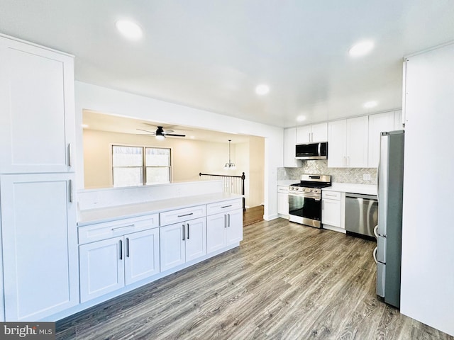 kitchen featuring white cabinetry, ceiling fan, stainless steel appliances, and light wood-type flooring