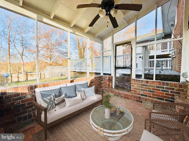 sunroom / solarium featuring ceiling fan and vaulted ceiling