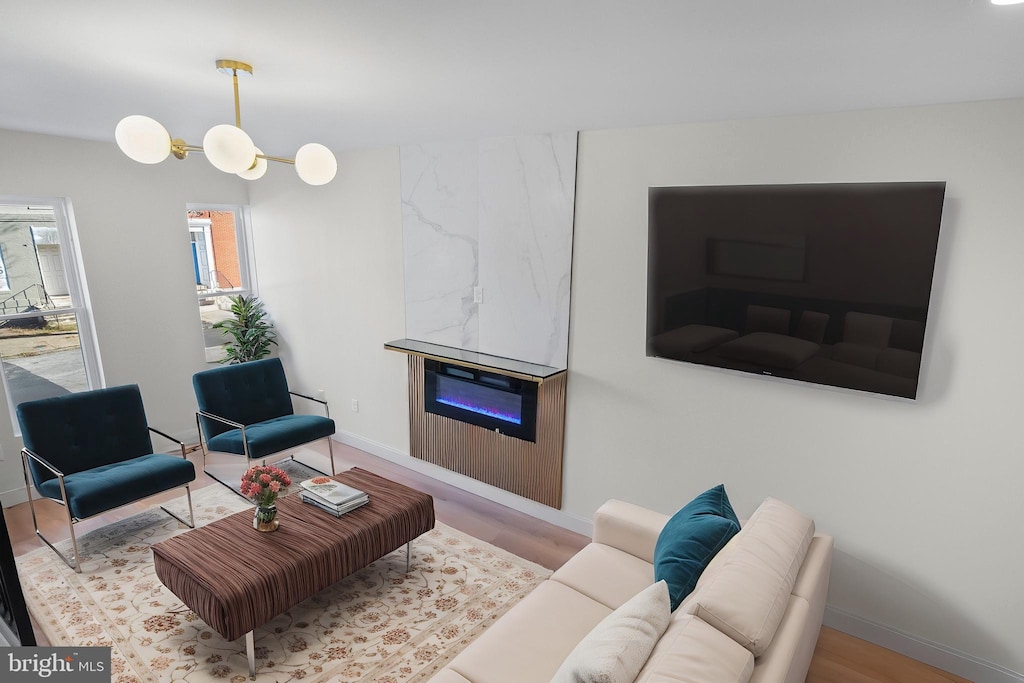 living room featuring a large fireplace and light hardwood / wood-style flooring