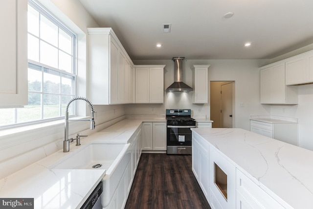 kitchen featuring dark wood-type flooring, white cabinets, wall chimney exhaust hood, light stone counters, and stainless steel appliances