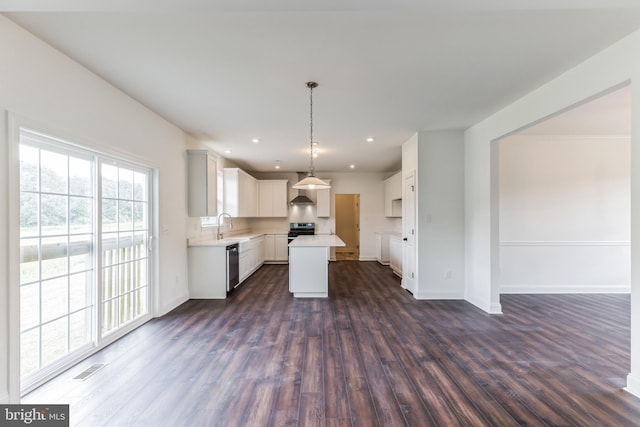 kitchen featuring white cabinetry, a kitchen island, hanging light fixtures, and dark hardwood / wood-style floors