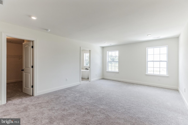 spare room featuring light colored carpet