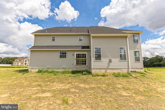 back of house featuring a yard