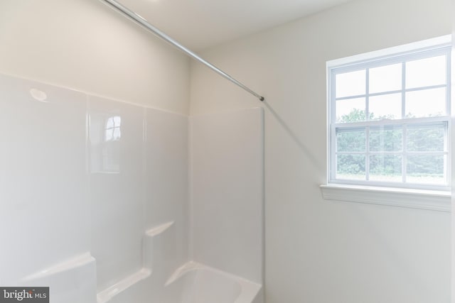 bathroom featuring a healthy amount of sunlight and shower / tub combination