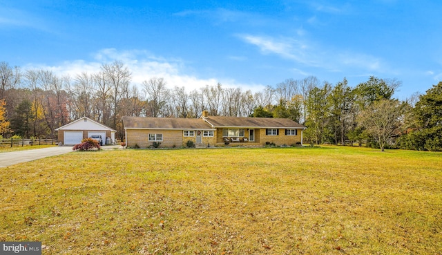 ranch-style house with an outbuilding, a front lawn, and a garage