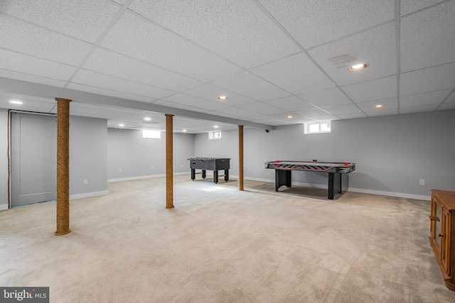 game room with a paneled ceiling and light colored carpet