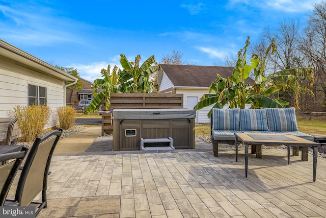 view of patio / terrace with an outdoor hangout area and a hot tub