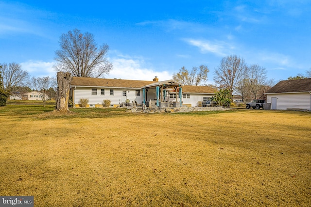 rear view of house featuring a lawn