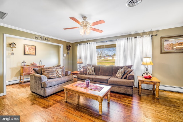 living room with hardwood / wood-style floors, ceiling fan, crown molding, and a baseboard heating unit