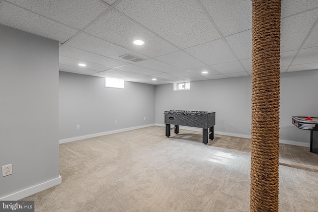 rec room with carpet and a paneled ceiling