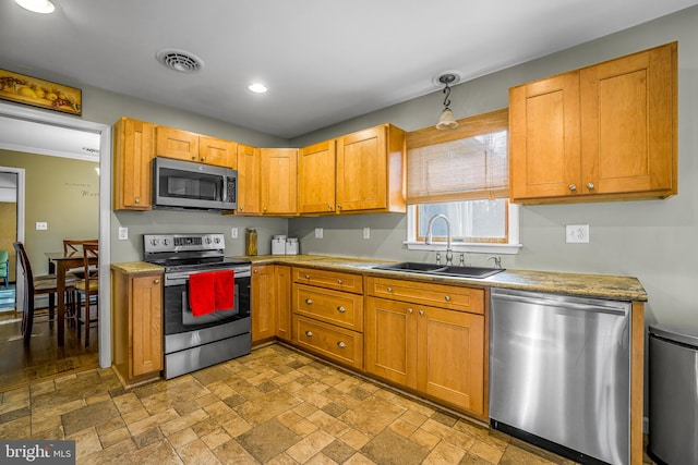 kitchen featuring sink, ornamental molding, and appliances with stainless steel finishes