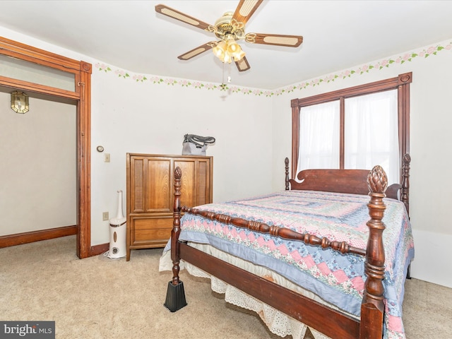 bedroom with ceiling fan and light carpet