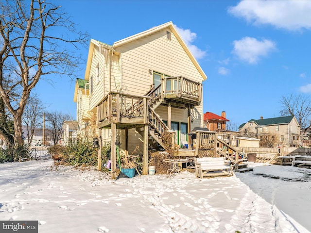 view of snow covered back of property