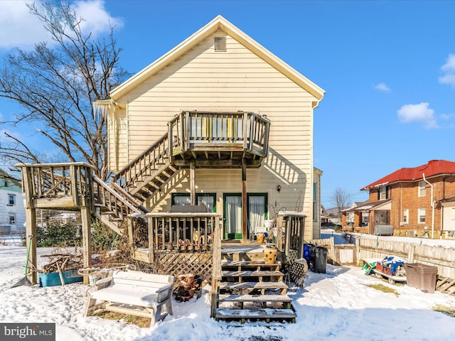 snow covered house with a deck