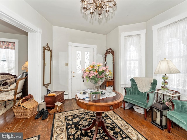 foyer featuring hardwood / wood-style floors and a chandelier