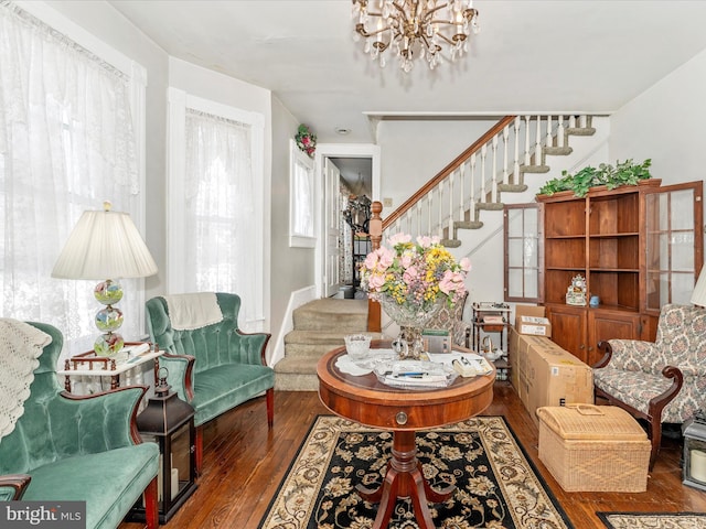 living area featuring hardwood / wood-style flooring and a notable chandelier