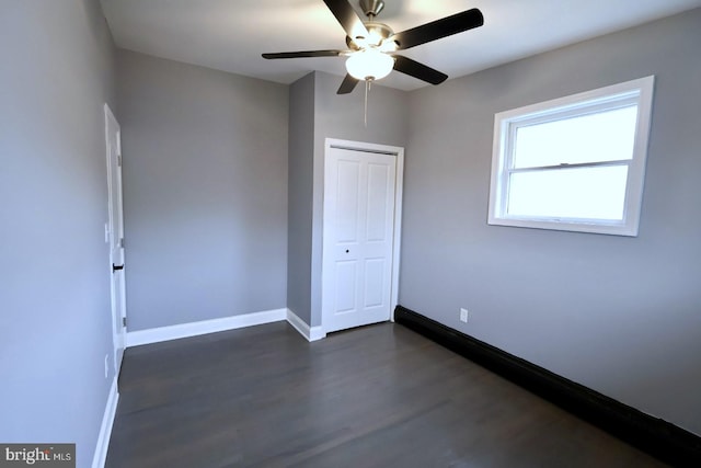 unfurnished bedroom with a closet, dark hardwood / wood-style floors, and ceiling fan