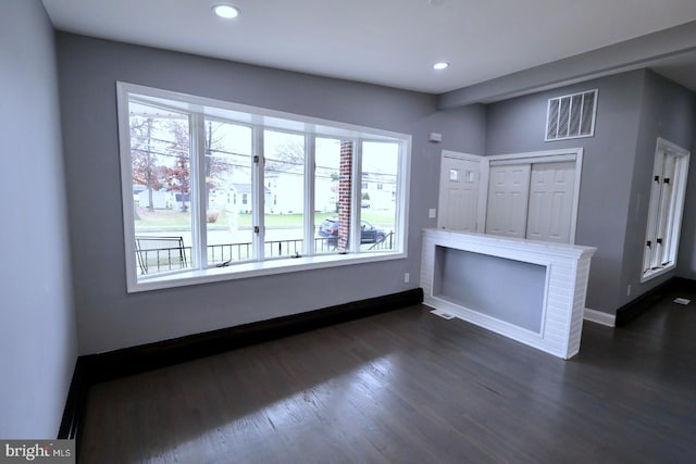 unfurnished living room featuring dark hardwood / wood-style flooring