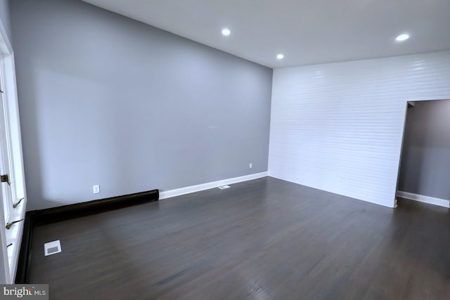 empty room featuring dark hardwood / wood-style floors