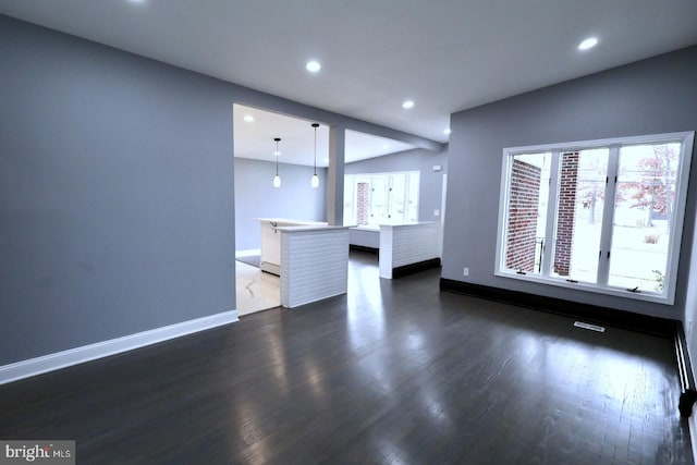 unfurnished living room featuring dark wood-type flooring and vaulted ceiling