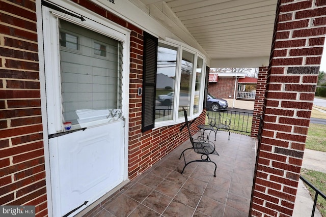 view of exterior entry featuring a porch