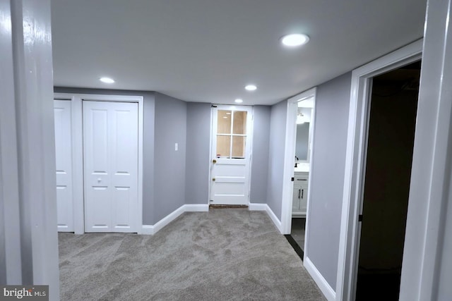 hall featuring light colored carpet