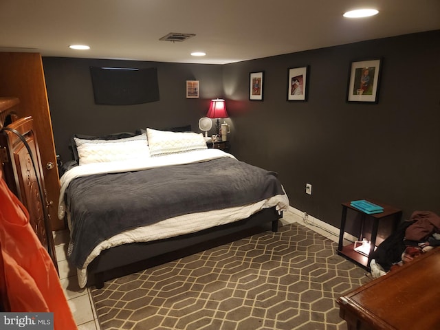 bedroom with dark tile patterned floors