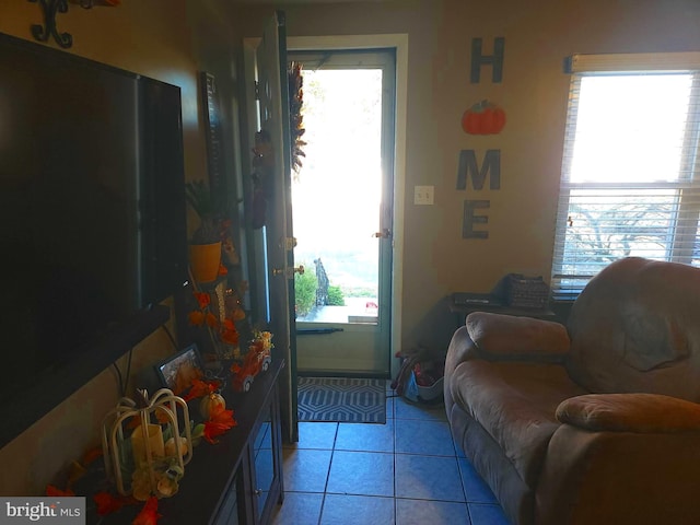 doorway to outside featuring a healthy amount of sunlight and light tile patterned floors