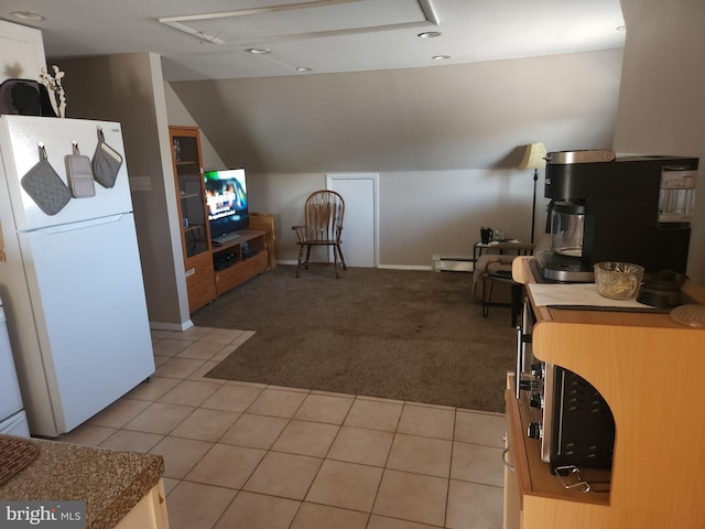 kitchen with baseboard heating, light carpet, white fridge, and vaulted ceiling