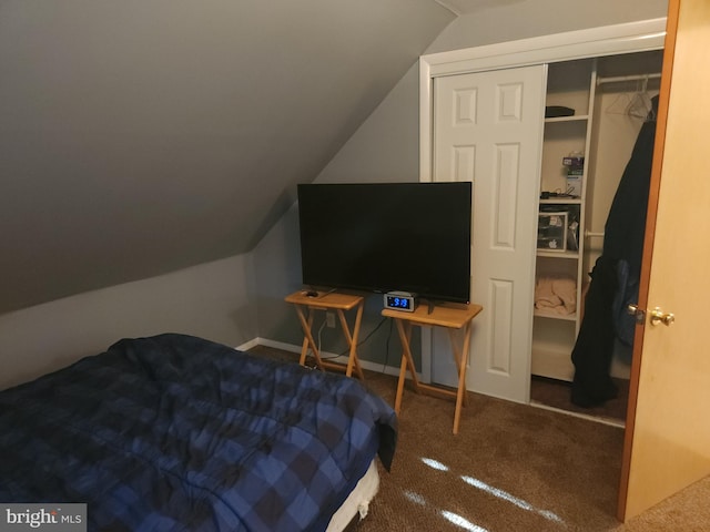 carpeted bedroom featuring a closet and vaulted ceiling