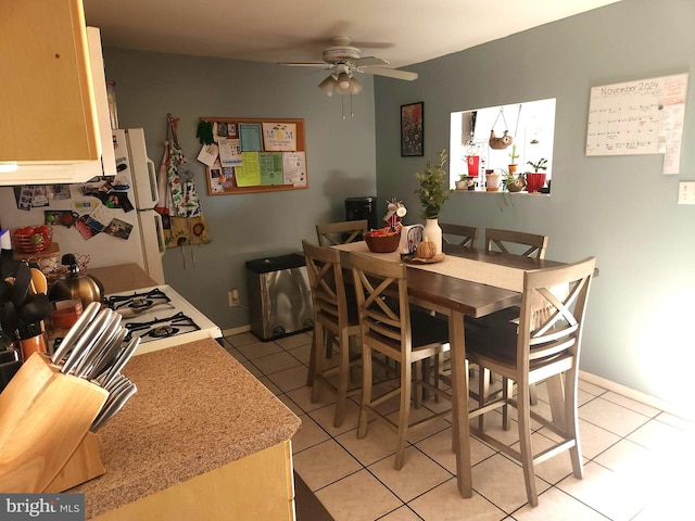 dining room with ceiling fan and light tile patterned flooring