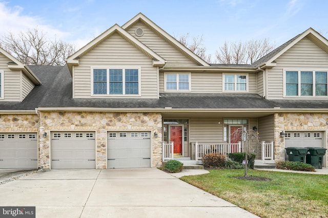 view of property featuring a front yard and a garage