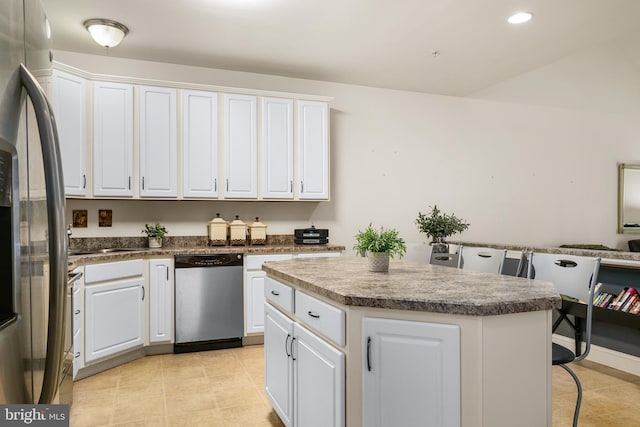 kitchen with a center island, white cabinetry, and stainless steel appliances