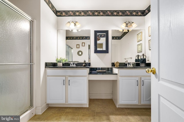 bathroom with tile patterned flooring, vanity, and a shower with door