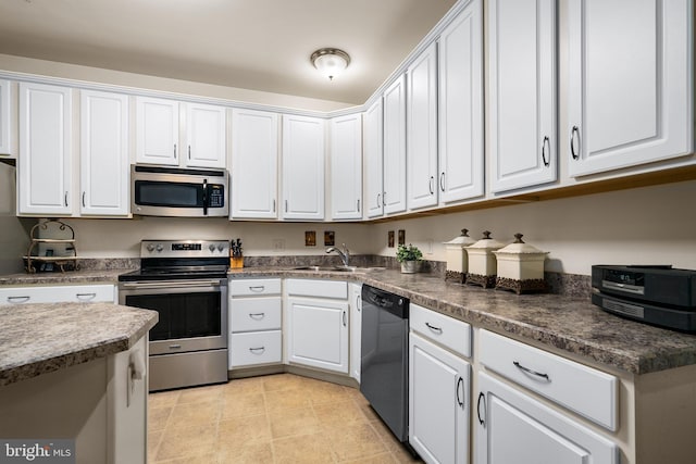 kitchen featuring white cabinetry, sink, and appliances with stainless steel finishes