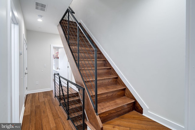 stairway featuring hardwood / wood-style floors