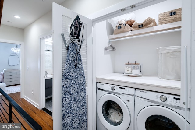 laundry room featuring washing machine and clothes dryer and dark hardwood / wood-style flooring