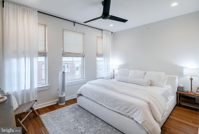 bedroom featuring ceiling fan and dark wood-type flooring