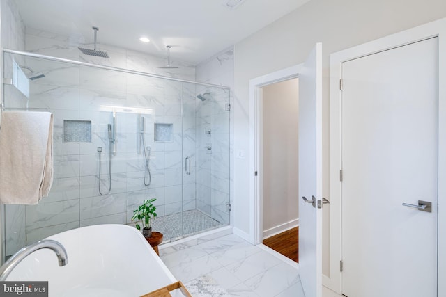 bathroom featuring shower with separate bathtub