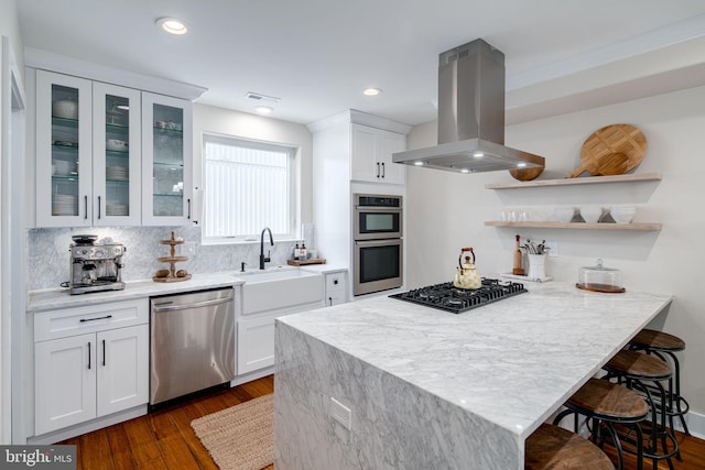 kitchen featuring white cabinets, island range hood, sink, and appliances with stainless steel finishes